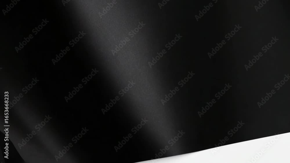 Poster a captivating black surface is illuminated by the soft glow of light creating a luxurious, sleek and