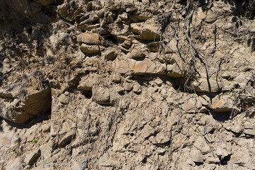 A detailed view of a quarry that is no longer in use. A detailed view of the crumbling remains of stone quarrying.