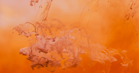 Pigment drop water. Steam flow. Brown paint drip in bright orange liquid. Hot color fume twist...