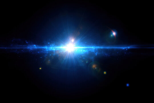 Glowing blue light burst with textured rays and lens flare effects shining brightly in dark space background, creating cosmic atmosphere