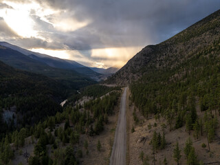 Fototapeta premium Scenic Winding Road Through Forested Mountains at Sunset in BC, Canada