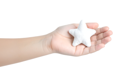 A hand holds a white plush star, symbolizing a dream, hope, and the aspiration for success.