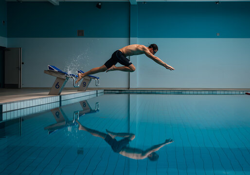 Person diving into swimming pool