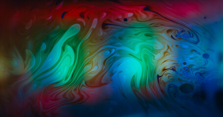 Fluorescent liquid blur. Psychedelic chemical ink. Colorful defocused lens flow swirl texture blending dye abstract glow background.