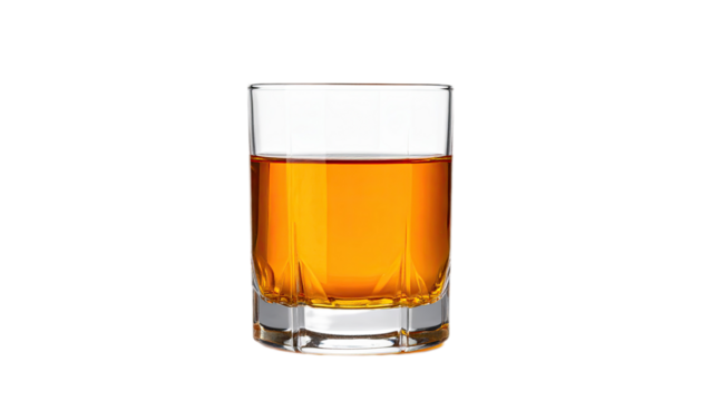 A shot glass filled with amber liquid against a black background.