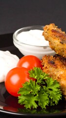 Crispy fried chicken with dipping sauce and tomatoes