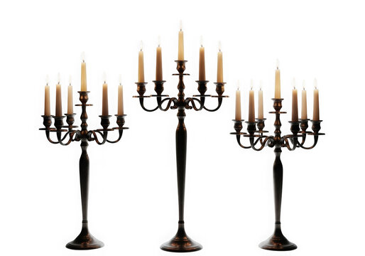 Three tall dark candelabras with lit candles isolated on transparent background