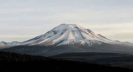 Fototapeta premium Majestic Snow-Capped Mountain Peak at Sunset