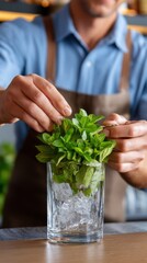 Bartender preparing a mint julep at the bar, with emphasis on the preparation process, focus on mint leaves, ice and glass 