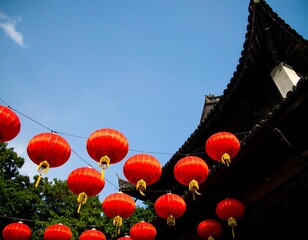 Obraz premium Red lanterns hang from a building under a clear sky
