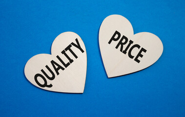 Price or Quality symbol. Concept word Price or Quality on wooden hearts. Beautiful blue background....