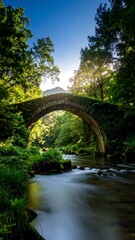 Ancient stone arch bridge over a flowing stream
