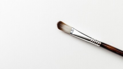 Fototapeta premium Calm paintbrush lying flat on minimalist tabletop in studio