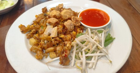 A local food of Phuket Province, Thailand, called O Tao, consists of small oysters coated in flour, fried and seasoned with a unique flavor.