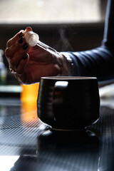 Adding a supplement to a hot beverage.