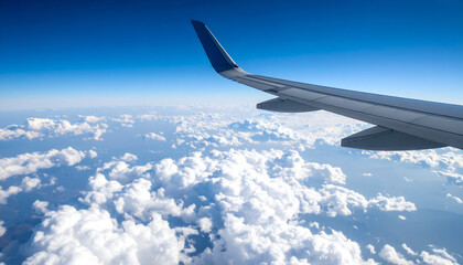 Obraz premium Airplane Wing Ascending Above a Sea of Clouds on a Bright Sunny Day with Blue Skies