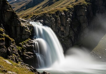 Obraz premium Serene Alpine Waterfall Cascading Down Rugged Rocky Cliffs Amidst Verdant Grassy Slopes