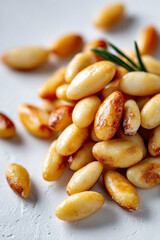 Ligurian pine nuts on white surface