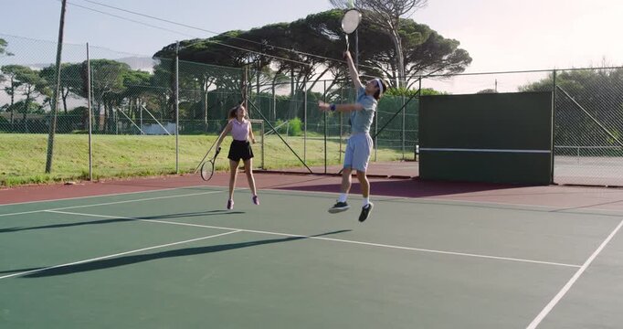 Starting volley drill, diverse tennis partners trading volleys and hi-five at net with rackets