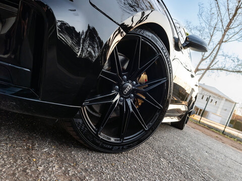 Black alloy wheel on an Audi A5 Sportback with a gold brake caliper, Modern luxury car custom wheel detail

