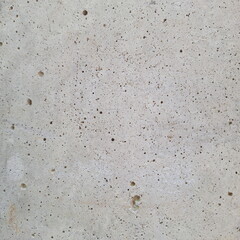 Close-up concrete wall texture with porous rough surface pattern