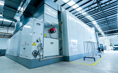 Modern car painting booth with advanced air filtration and technology, supporting insurance claims...