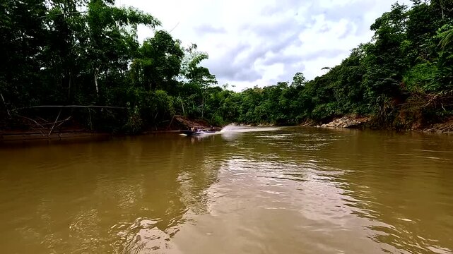 Canelos, Ecuador - 2 September 2024: a canoe is passing by in slow motion with passengers from the Amazon going to the city