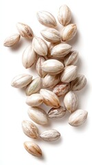 Scattered Light Brown And White Pistachios On White Background
