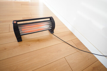 Portable heater warming a room during a cold day