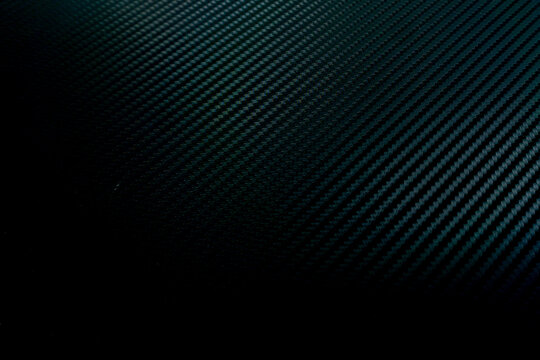 close-up of a carbon fiber pattern, black abstract background