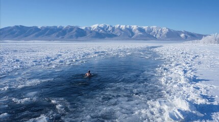 Naklejka premium A man is swimming in a frozen river. The water is cold and the sky is clear. The man is the only person in the scene