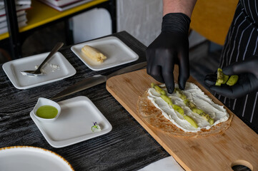 The cook prepares a fruit roll from pancakes. 