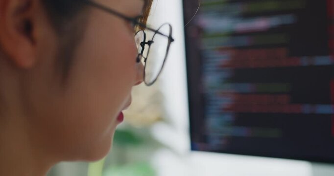 Closeup of young Asia female freelance eyeglasses type write prompt AI bot IT app smart program nomad, video game, terminal with coding, user interface, data center on desktop computer at home office.