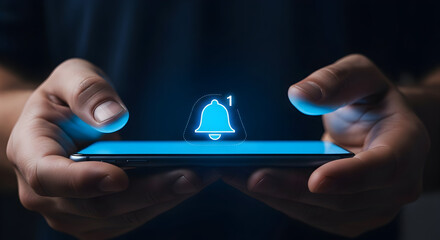 Person holding a smartphone with a glowing notification bell icon on screen, indicating alerts and updates, close-up, tech concept.
