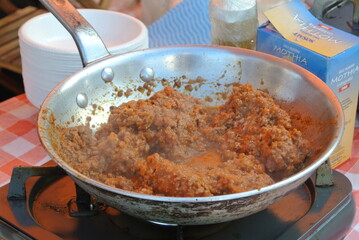 cooking meat in a pan