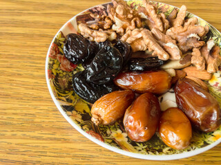 Plate of dried fruits and nuts showing healthy lifestyle