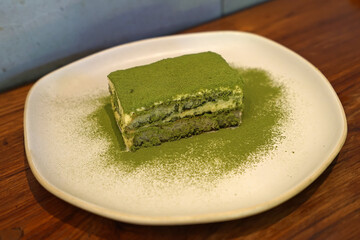 Close up dish of green tea Tiramisu, Matcha soaked ladyfingers layered with a light and airy...