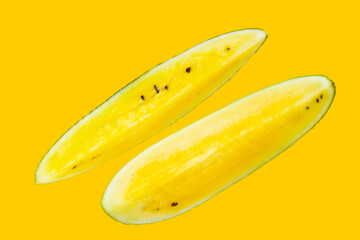 Yellow watermelon slices on yellow background.