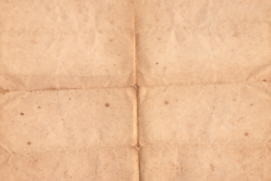 Folded Vintage Old Paper Texture Background. Weathered antique paper folded in four. Brown crumpled and folded parchment vintage paper sheet with space for text - Powered by Adobe