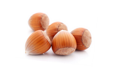 Pile of hazelnuts on a white background