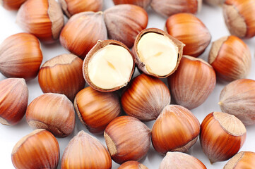 Pile of hazelnuts on a white background