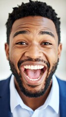 Close-up portrait of a man with a wide, joyful smile