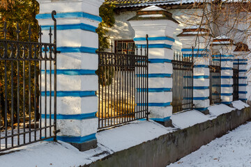 Decorative fence with white and blue brick pillars