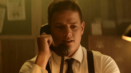 Businessman making a phone call in vintage office setting