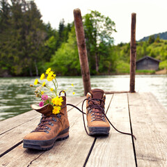 Autumn Serenity: Wildflowers in Hiking Boots by the Mountain Lake