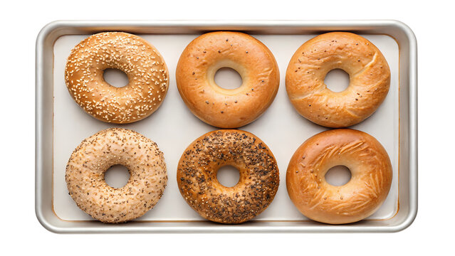 Six assorted bagels on a baking tray isolated on transparent background