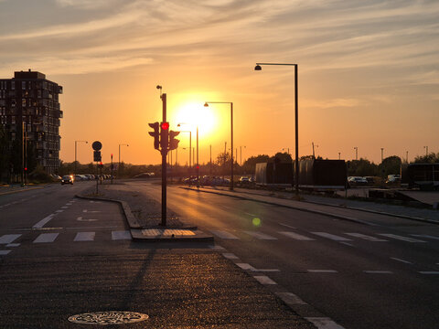 Orestad, Denmark, sunset, street, traffic lights, warm light, evening, urban scene, roadway, cityscape, silhouette, sky, clouds, modern building, calm, transportation, intersection, quiet street, gold