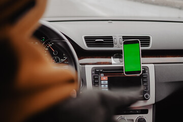 Millennial man drive the car and using mobile app , green screen
