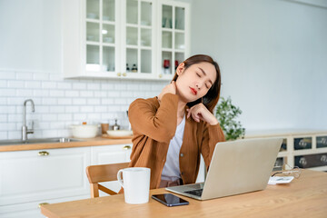 Office syndrome concept. Young asian woman feeling pain in neck and shoulder after working on...