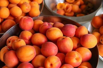 Ripe, juicy apricots in bowls, preparation of apricots for jam